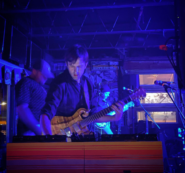 Jeremy Chambers performing guitar on stage